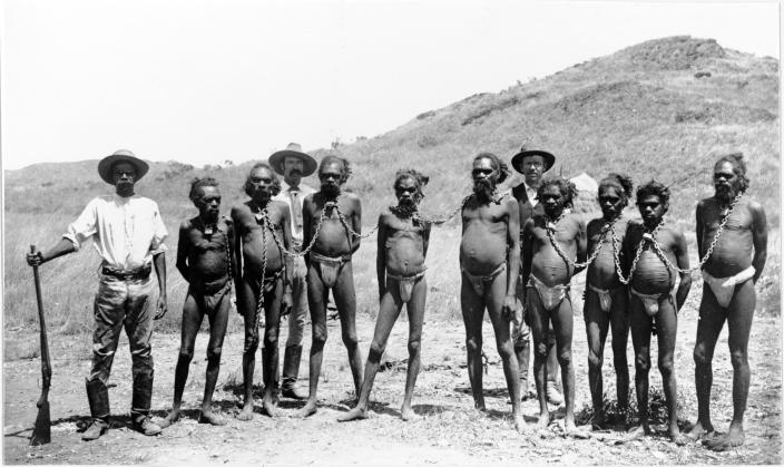 Group of prisoners standing chained together